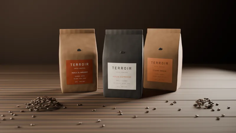 Bags of Terroir coffee on the roastery bench under warm light, each printed with a roast date